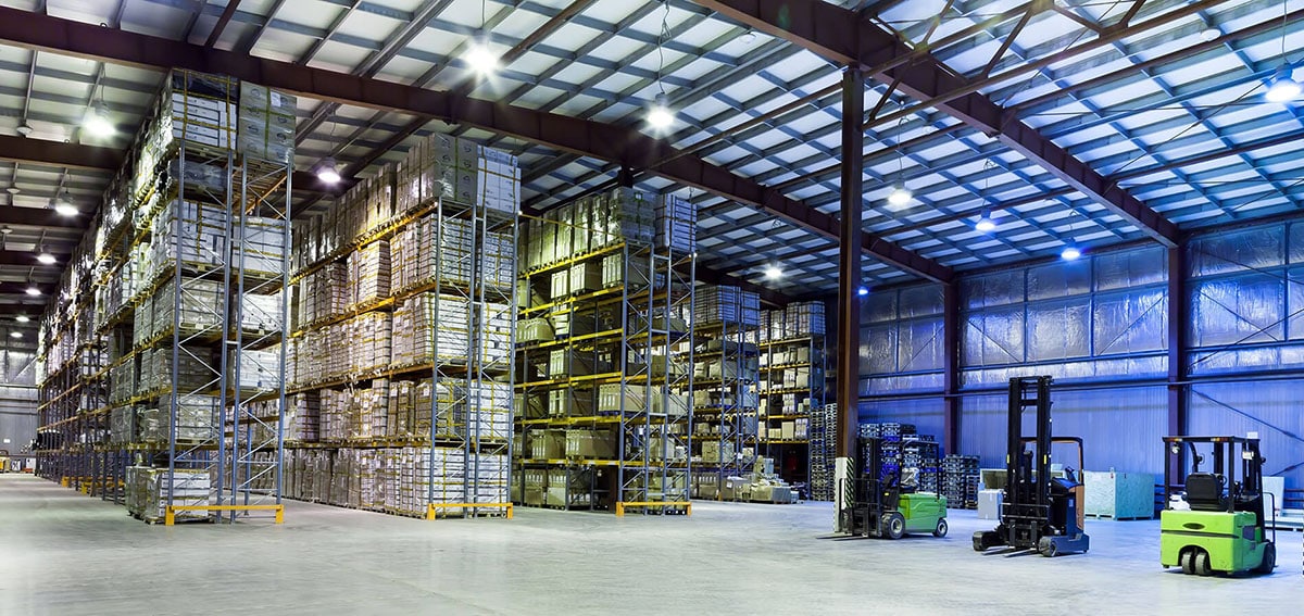 Industrial warehouse interior with numerous floor to ceiling pallets